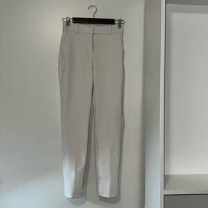 Off-white slim fit dress pants.